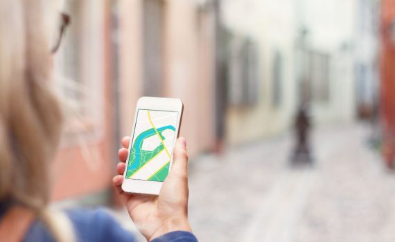 Woman navigating in a city with her mobile phone