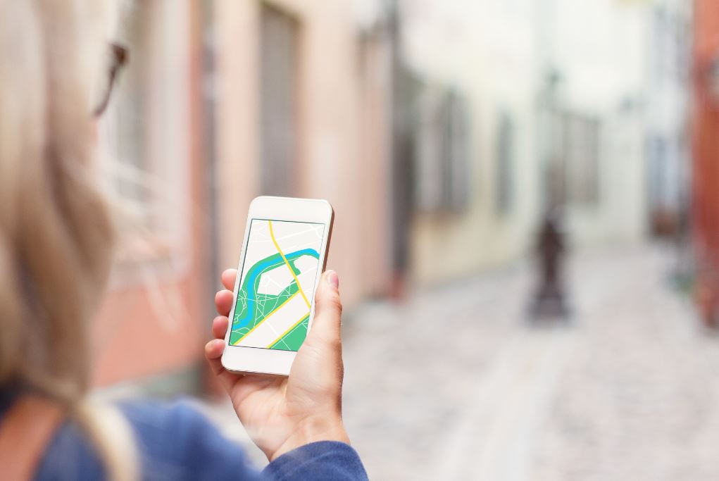 Woman navigating in a city with her mobile phone